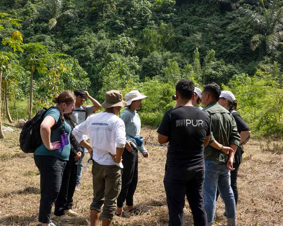 PUR Staff visiting a farmer's parcel in Indonesia.