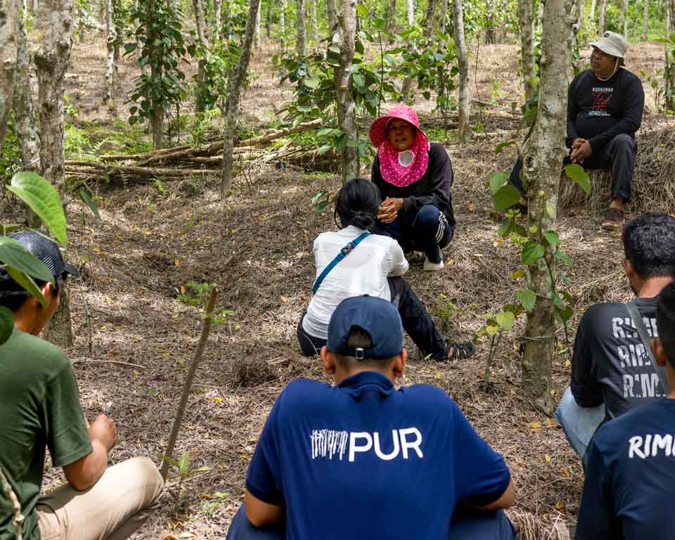 PUR Team visiting a woman farmer in Indonesia.
